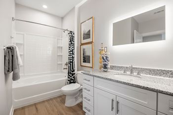 a bathroom with a shower and a sink and a toilet